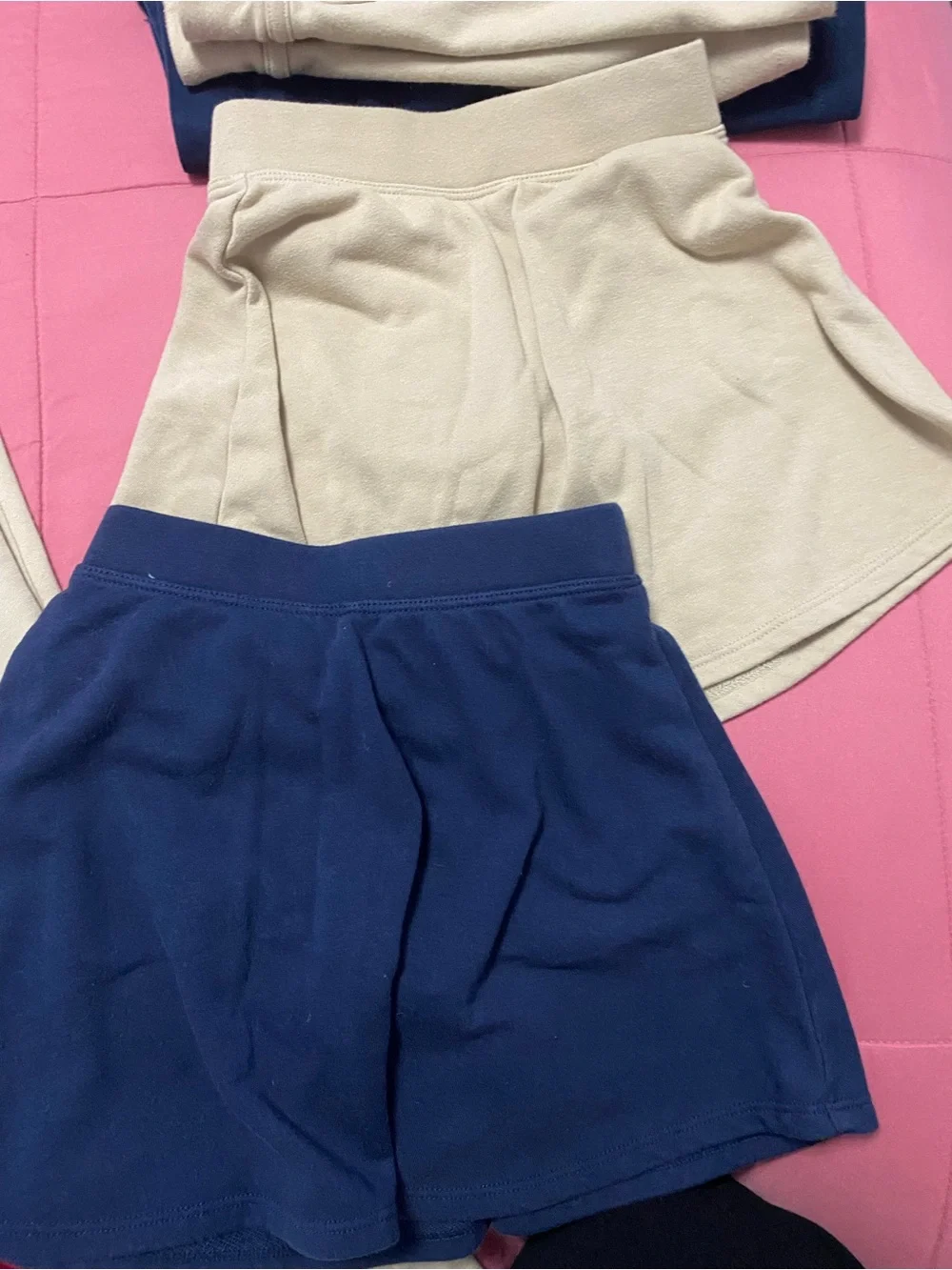 Lot of girl uniforms. Tan navy blue white and red.
